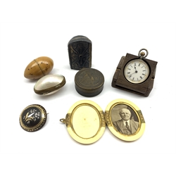 Small collectible items including coquille nut cotton reel holder, Swiss fob watch with silver case in a Swiss carved wooden holder, late 19th/early 20th century oval folding ivory photograph frame, metal rouge pot, miniature folding Icon and two other items