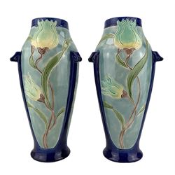 Pair of Burmantofts Faience three-handled vases, designed by Joseph Walmsley, each of elongated ovoid form, incised and glazed with tulips, impressed factory marks beneath, model no. 2246, H27cm 