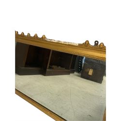 19th century giltwood and gesso triptych overmantel mirror, foliate and ovoid decorated cornice over three mirror plates, the plates divided by Composite columns, applied lion mask and anthemion motifs