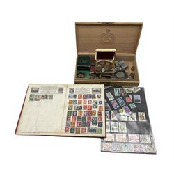 Queen Victoria 1889 crown coin, King George VI 1951 Festival Of Britain and other commemorative crowns, World coins etc, cap badges including 'Manchester', 'The West Riding' etc and various Great British and World stamps, in one box
