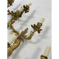 Set of four modern gilt brass two branch wall lights of rococo design, height of backplate 36cm, 