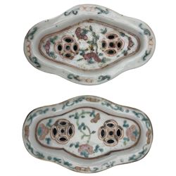 Pair of 19th century Chinese famille verte quatrefoil stem dishes, decorated with figures and foliage, L19cm together with a pair of 19th century Chinese famille rose cricket boxes and covers, each of lozenge form painted with figures in a garden, L12.5cm. Provenance: From the Estate of the late Dowager Lady St Oswald