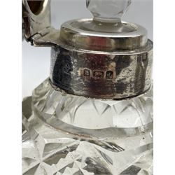 Edwardian silver and cut glass scent bottle with embossed cover and Art Nouveau style pierced silver base by William Hutton & Sons, Birmingham 1907 together with a Sterling silver mounted glass atomizer (2)