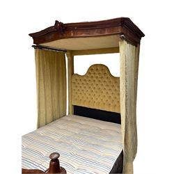 19th century walnut half tester 5’ kingsize bedstead, the projecting canopy with moulded cornice and carved central cartouche, the back upholstered in buttoned cream fabric with foliate pattern, matching curtains, shaped footboard with s-scroll supports enclosing quarter veneered front, the front with applied scrolling mouldings and cartouche, together with mattress