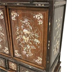 Early 20th century Chinese hardwood and mother of pearl inlaid panelled cabinet, decorated with warrior scenes, trailing foliate patterns and bird motifs, on shaped apron and curved bracket feeet