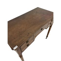 Regency mahogany writing table, the rectangular top over one long and two short drawers, raised on turned supports terminating in brass castors 