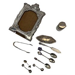 Silver upright table photograph frame with tied bow and cartouche finial Birmingham 1910 Maker William Adams, glass and silver mounted salts bottle, dressing table box and cover, silver sugar tongs and other small pieces 