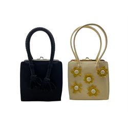 Two Anya Hindmarch handbags, the first in black with rope twist handles and the other in cream with applied felt flowers and gold coloured hardware (2)