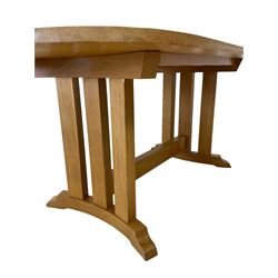 Solid light oak dining table, rounded rectangular top on a series of upright supports, curved sledge feet