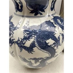 Chinese blue and white Dragon vase of lobed form, another Chinese blue and white vase and an Oriental stoneware stick stand decorated with panels of Eagles and Cranes, H44cm 