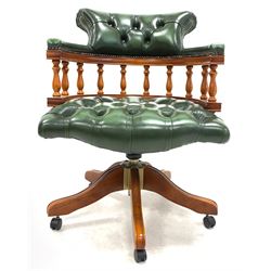 Late 20th century captains desk chair, upholstered in deep buttoned green leather, raised on a five point swivel base with castors W62cm