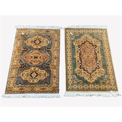 Persian design ground rug, with floral decoration on a teal field, enclosed by border (195cm x 120cm) together with a similar ground rug, (195cm x 122cm)