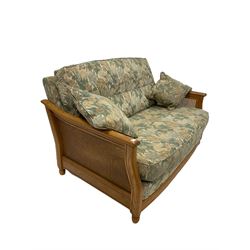 Contemporary Ercol suite, comprising of elm and bergere framed two and a three seater sofa, upholstered in floral fabric 