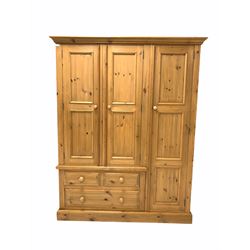 Waxed pine triple wardrobe, cornice over full length cupboard and two others with interior fitted for hanging, three drawers under, raised on plinth base W153cm, H193cm, D62cm