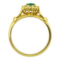 18ct gold oval emerald and round brilliant cut diamond cluster ring, stamped 750