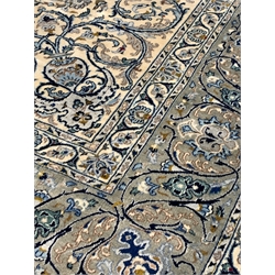 Fine Kashan ivory carpet, blue floral medallion to centre of busy field, enclosed by triple guarded border, 425cm x 323cm