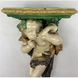 Early Victorian Minton Majolica wall bracket designed by Albert Carrier Belleuse, modelled as a Faun with a hunting horn, carrying a fox on his shoulder, with egg and dart shaped platform, stamped verso, 1842, H50cm x W30cm