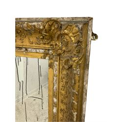 19th century giltwood and gesso wall mirror, the frame decorated with trailing foliage and floral cartouches, plain mirror plate