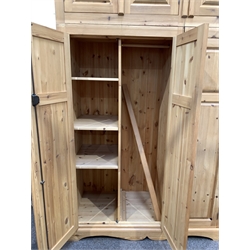 Pine triple wardrobe, with three cupboards over three full length cupboards enclosing interior fitted for hanging and with shelves, raised on shaped plinth base, W144cm, H239cm, D65cm