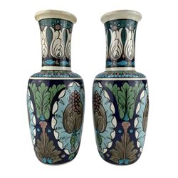 Pair of Burmantofts Faience Anglo-Persian vases, designed by Leonard King, of shouldered form, painted with stylized flowers and foliage against a blue ground, impressed factory marks, model no. 167, incised D.601, 2851 & 2851 and artists monogram LK, H30cm