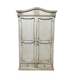20th century white armoire, the carved frieze over two doors opening to reveal three shelves and two drawers, raised on a plinth base W119cm, H195cm, D61cm   