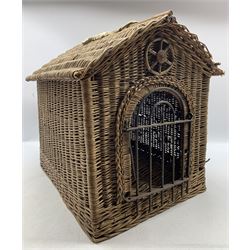 Early 20th century English wicker work animal carrier or kennel, of architectural form with pitched roof, arched doorway with six spoked wheel motif pediment and arched iron gate, L56cm, W42cm, H47cm 
