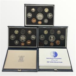 Three Royal Mint Bailiwick of Guernsey proof coin collections, dated 1986 and 1987 cased with certificates and 1985 cased without certificate 