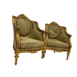 Pair Louis XVI design gilt framed armchairs, the cresting rail pierced and moulded with flower heads, central back panel framed with gilt ribbon design, scrolled arm terminals decorated with acanthus leaves, the apron with flower heads and rosettes raised on turned tapering supports, upholstered in foliate patterned laurel green fabric with sprung seat