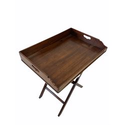 Mahogany butlers tray on stand, the 19th century tray with pierced carry handles raised on a later folding base W70cm H83cm