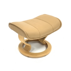 Stressless reclining armchair upholstered in tan leather, (W78cm) together with a matching footstool 
