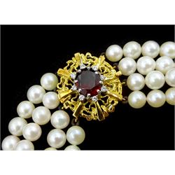 Four strand cultured pearl choker necklace, with 18ct gold oval cut garnet and round brilliant cut diamond clasp, with original receipt