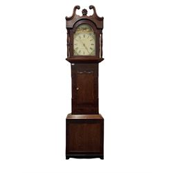 An oak and mahogany 30hour longcase clock c1850 with a swans neck pediment, carved wooden patera and radiating carved boss, glazed break arch hood door flanked by two ring turned pillars, with a mahogany veneered trunk, stopped reeded corner pillars and a short wavy toped door in contrasting oak, trunk on a square plinth with a recessed panel and shaped feet, 13” break arch painted dial with Roman numerals, minute track and stamped brass “crown” hands within a gold border, matching painted cornflowers to the spandrels, break arch with a rural scene representing a farmer watering his horse, dial inscribed “Thwaites, Barnard Castle”, with a 30hr chain driven countwheel movement sounding the hours on a cast bell.
With weight and pendulum. 
This clock and its history was the subject of a two-part article in “CLOCKS” magazine in November and December 2018, the clock is accompanied by copies of the articles provided by the vendor.




