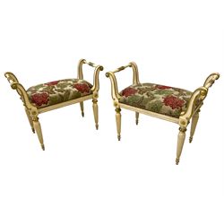 Pair Louis XVI design ivory and gilt painted dressing stools, the scrolled side rests united by stretcher with acanthus leaf moulding, upholstered in foliate fabric with studwork border, raised on reeded tapering supports