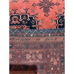 Afghan rug, the red field with geometric motifs, surrounded by borders with floral motifs 