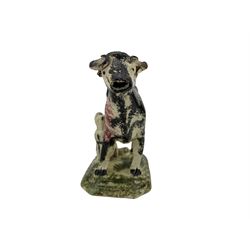 Early 19th century creamware cow creamer, probably North East, with curled tail handle, a milkmaid seated to one side with pail, decorated with sponged black and puce and set on a canted rectangular base sponged in green, L19cm x H15cm approx