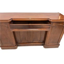 Victorian mahogany breakfront sideboard, fitted with single frieze drawer over double arch panelled cupboard, the flanking cupboards enclosing sliding trays and drawers