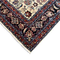 Persian ivory ground square rug, central floral pole medallion with surrounding palmettes connected by scrolling branches, the indigo border with crimson guards decorated with  stylised foliate motifs and leafage