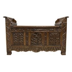 Oak window seat with hinged lifting seat over base with carved Gothic style arches 
