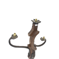 Wrought iron and hardwood standard lamp, with three light fittings and raised on three splayed supports 