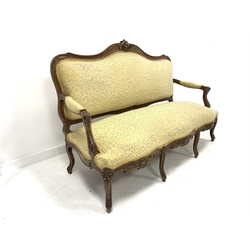 Victorian French style walnut canape, with gilt floral carved cresting rail over scrolled and acanthus carved open arms, raised on six cabriole supports, upholstered in oversprung ivory floral fabric, W170cm, H109cm, D60cm