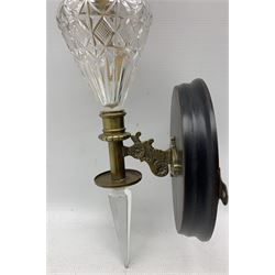 Edwardian wall mounted oil lamp, with brass mounts and oil reservoir of graduated form H57cm