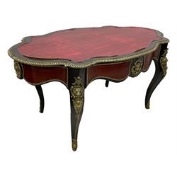 Mid-20th century French Empire design ebonised and mahogany centre table, the shaped top with egg and dart moulded cast gilt metal edge, shaped frieze rails with foliate mouldings and cartouche mounts, fitted with single drawer, on cabriole supports with ornate scroll and lion mask mounts
