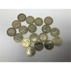 Twelve Queen Elizabeth II 1990 five pound coins each on card, twenty old style two pound coins and eighteen bi-metallic mostly commemorative two pound coins