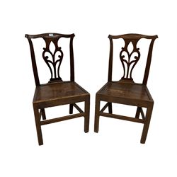 Pair Georgian elm country chairs, pierced splat back over panelled seat, raised on square supports