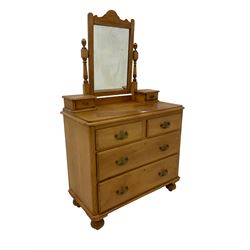 Late 19th century pine dressing chest, rectangular swing mirror raised on turned uprights flanked by two trinket drawers, fitted with two short and two long drawers raised on bun feet