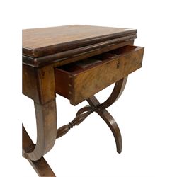 Charles X mahogany tea table, rectangular fold-over and swivel top with oval baize lined interior and moulded edge, fitted with single drawer, raised on a curved X-frame base united by a swell and ring turned stretcher
Provenance: From the Estate of the late Dowager Lady St Oswald