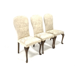 Set of three early 20th century Queen Anne style stained beech chairs, upholstered in white damask fabric, raised on shell carved cabriole front supports 