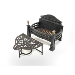 Cast iron fire grate with brass finials, (W50cm) and a 20th century demi lune cast iron footman (W39cm)