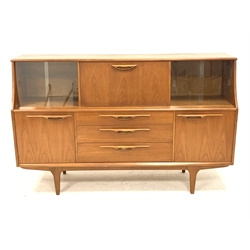 1970s teak sideboard, central fall front flanked by two sets of sliding glass doors, three drawers and two cupboards below, W167cm, H104cm, D44cm