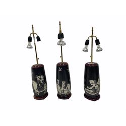 Three 20th century Oriental twin-branch pottery table lamps with figural decoration and brass telescopic fittings, H81cm max (3)